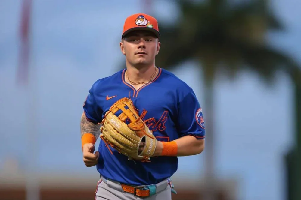 A.J. Ewing runs to the dugout with his glove on his left hand during a spring training game.