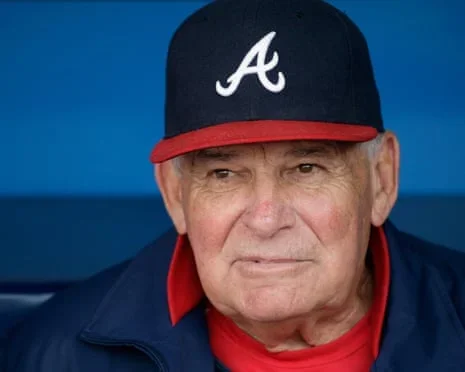Bobby Cox sits in the dugout during an Atlanta Braves game.